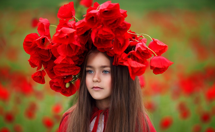 Girl with a wreath of red poppies
