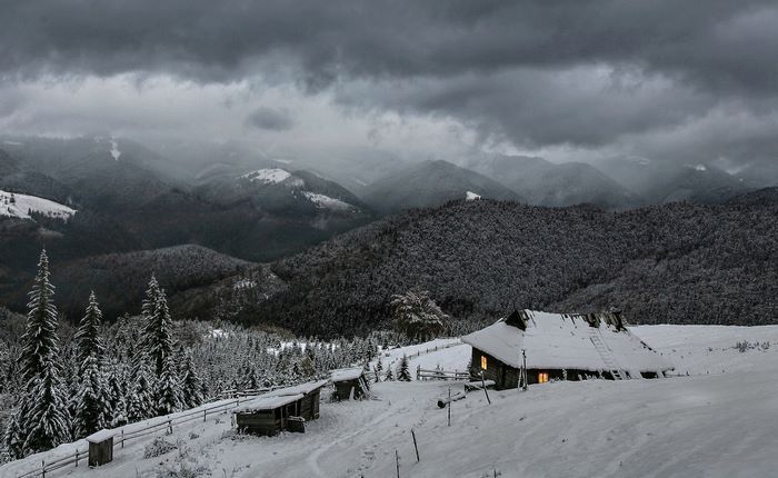 Winter mountain landscape with cabins and snow