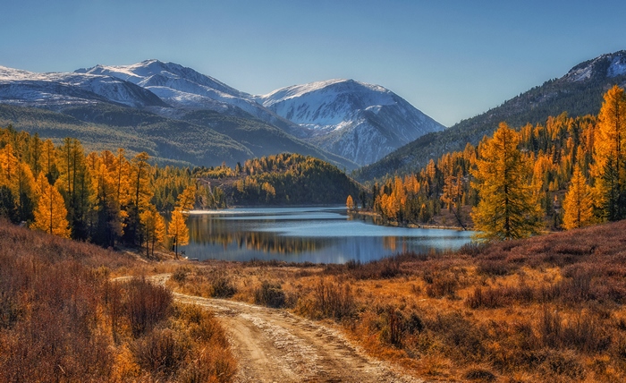 Autumn mountain lake with a dirt path