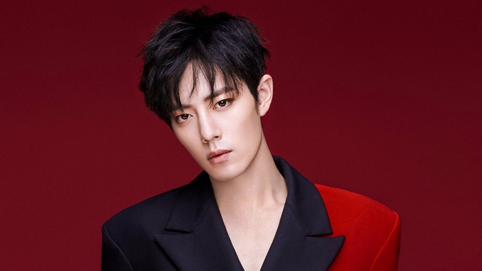 Xiao Zhan in a black and red suit