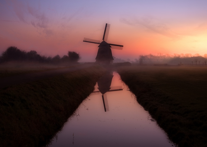Windmill reflection at sunset in Netherlands