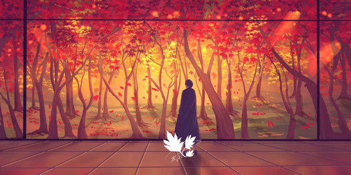 Person in dark cloak in autumn forest