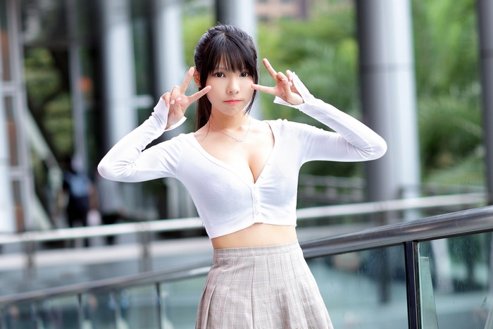 Asian woman with black hair making peace signs