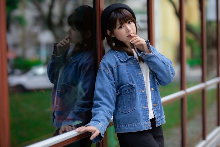 Asian woman in denim jacket and beret