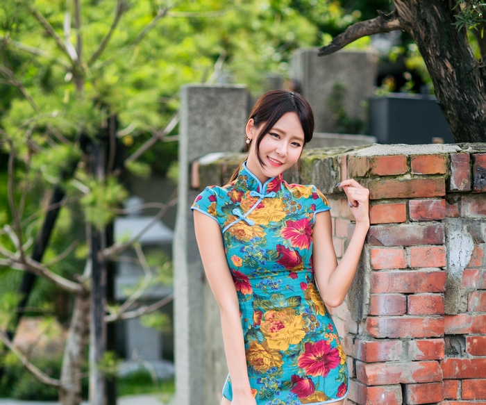 Woman in a floral cheongsam dress