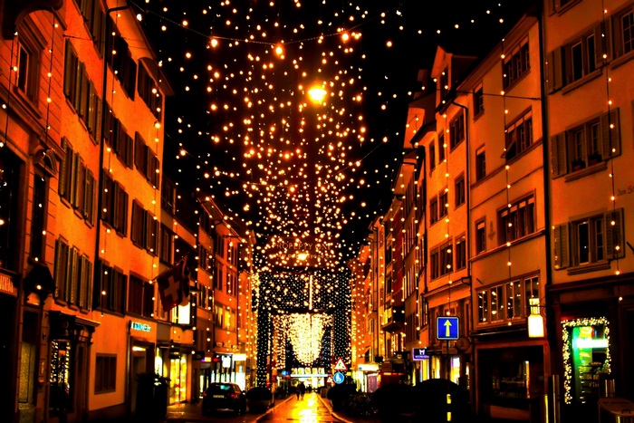Street decorated with Christmas lights at night