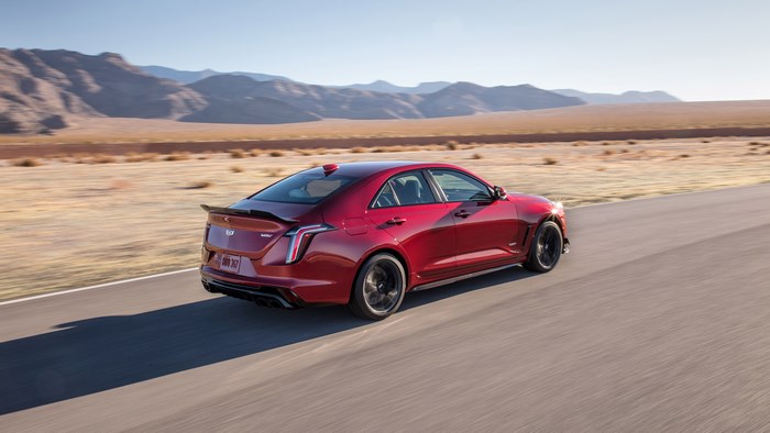 Red Cadillac CT4 driving on a desert road