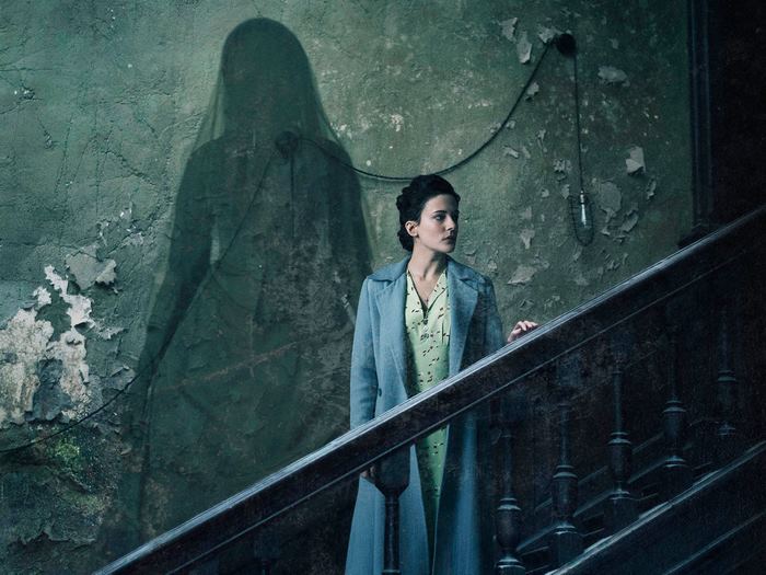 Woman on stairs with ghost shadow
