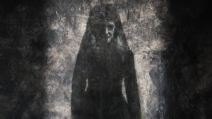 A shadowy figure in a dark room