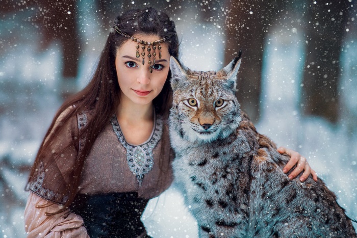 Woman with Lynx in Snowy Forest