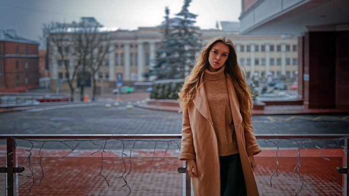 Woman in a coat and sweater