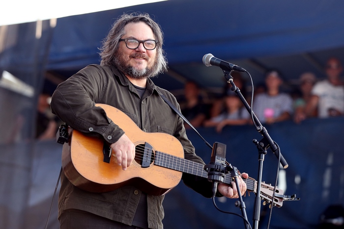 Jeff Tweedy playing guitar on stage