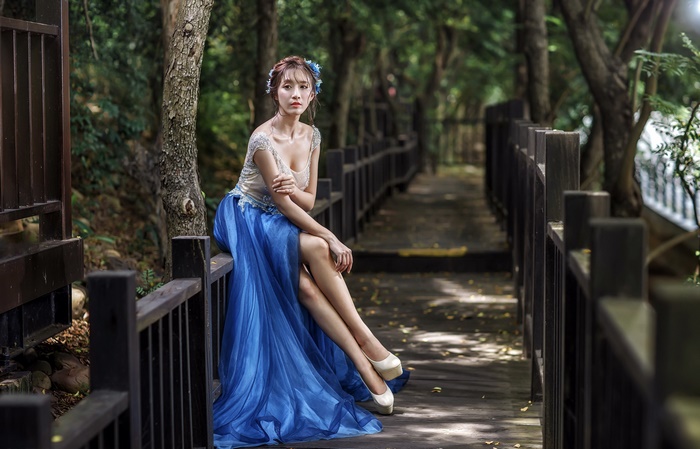 Asian Woman in Elegant Blue Dress on Forest Path