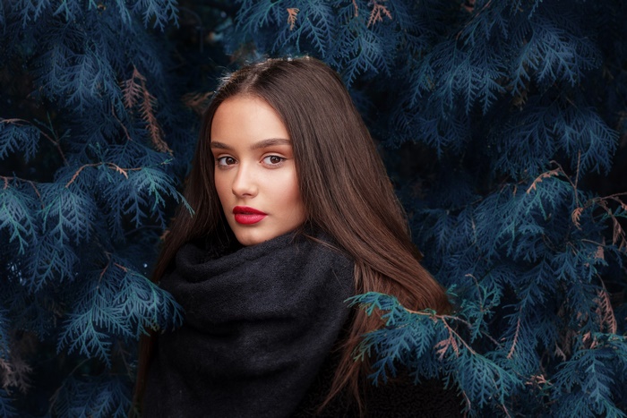 Woman with dark hair and red lipstick