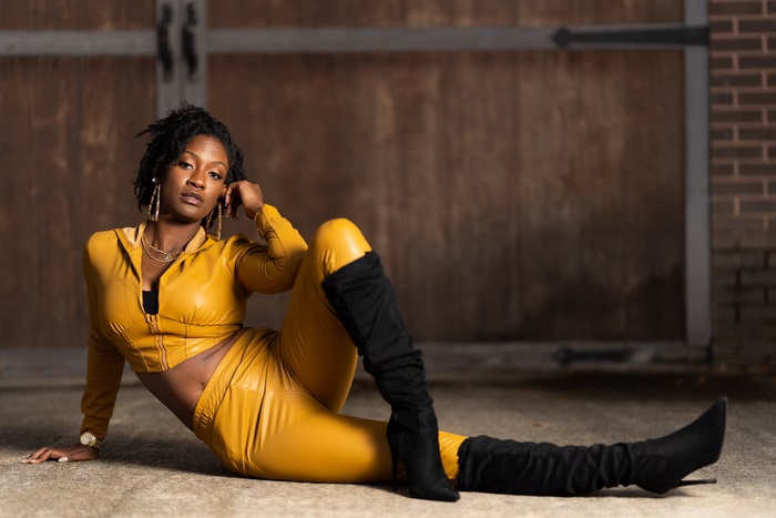 Stylish Woman in Yellow Outfit with Black Boots 4K