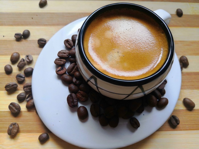 Espresso coffee in a cup with coffee beans