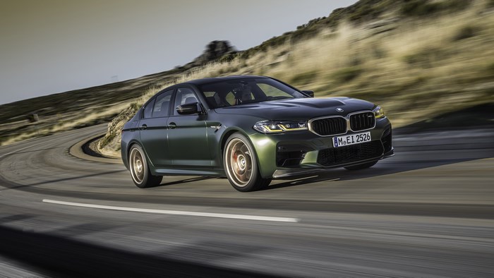 Green BMW M5 Driving on a Winding Road
