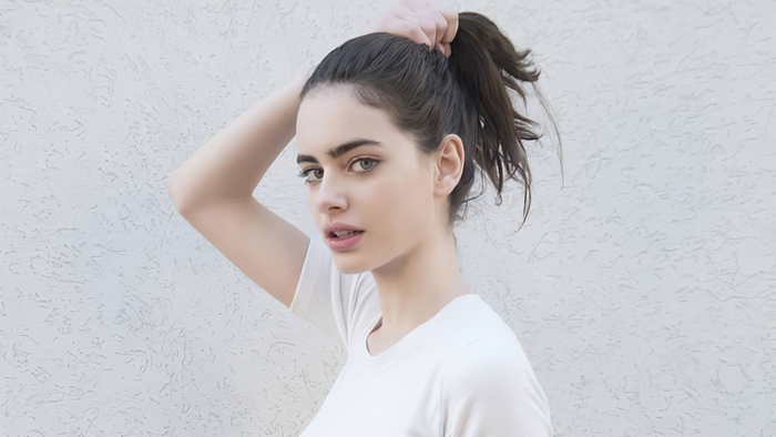 Yael Shelbia with dark hair pulled into a ponytail