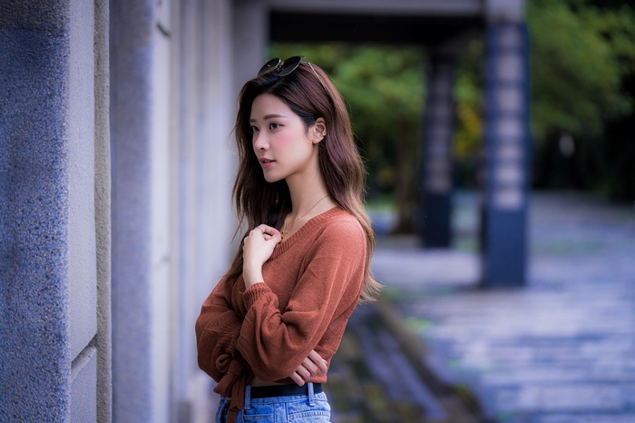 Asian woman with long brown hair and sunglasses
