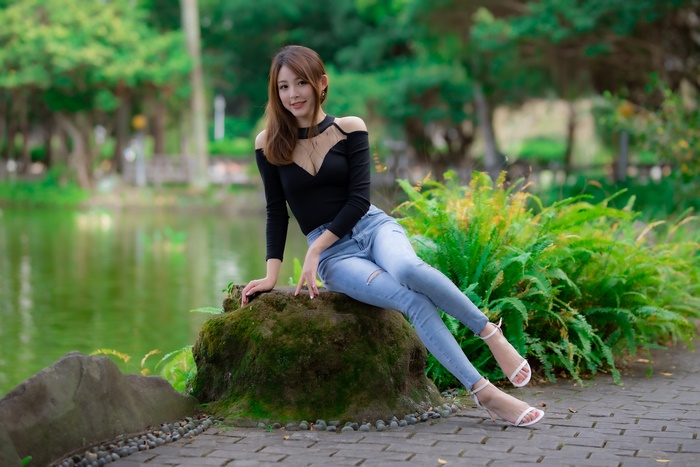 4K Image of Asian Woman Sitting Outdoors