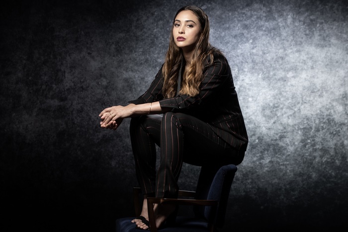 Lindsey Morgan sitting on a chair