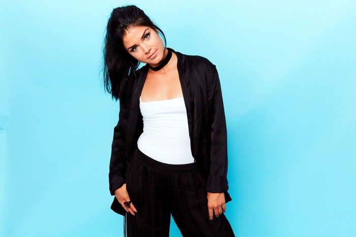 Marie Avgeropoulos wearing a black blazer and white top