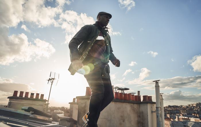Omar Sy as Lupin on a rooftop