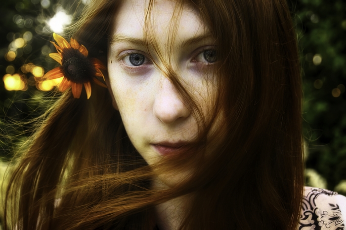 Redhead woman with flower in hair