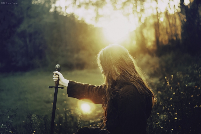 Girl with sword at sunset