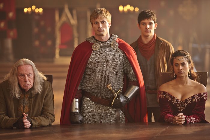Arthur, Merlin, Gaius, and Guinevere at the Round Table