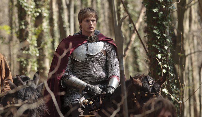 Arthur from Merlin on horseback in a forest