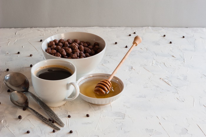 Breakfast with coffee, cereal, and honey