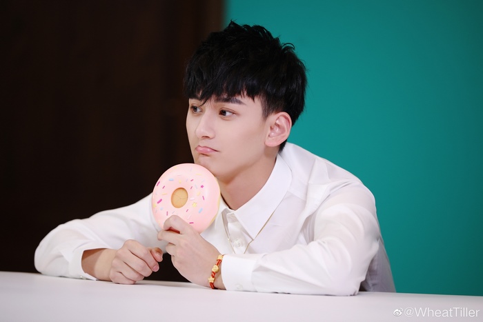 Ji Li holding a donut