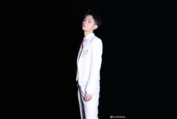 Ji Li in a white suit