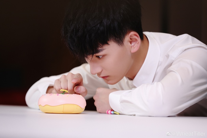 Ji Li looking at a donut toy
