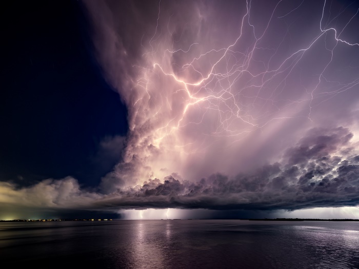 Lightning storm over the sea at night