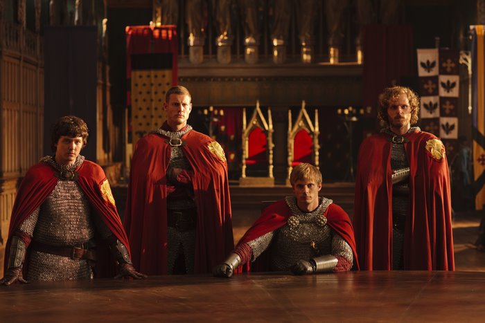 Four Knights in Red Capes in a Hall