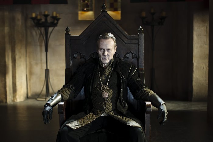 Uther Pendragon from Merlin sitting on a throne