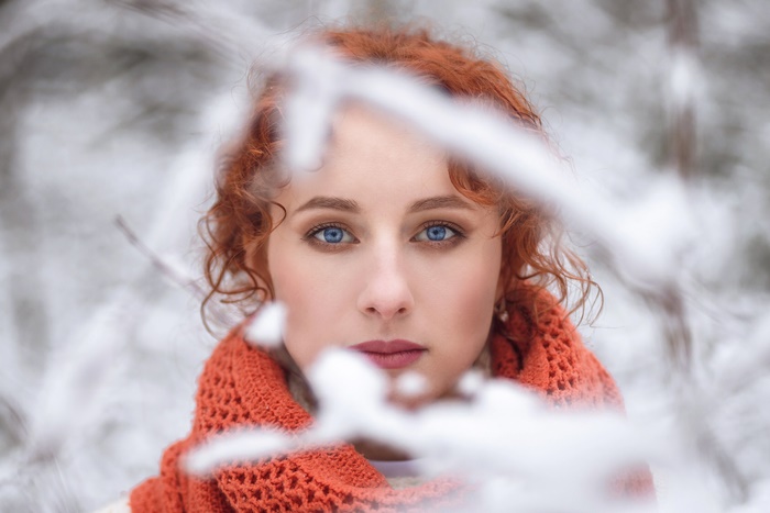 Woman with red hair and blue eyes in winter
