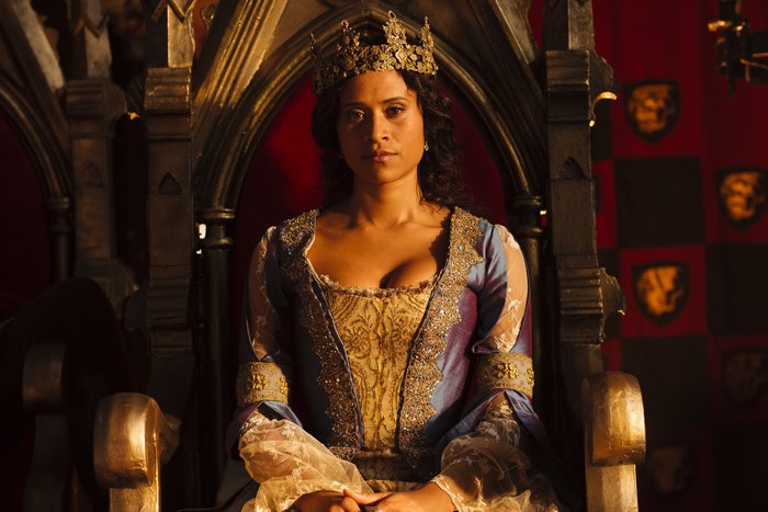 Guinevere from Merlin sitting on a throne