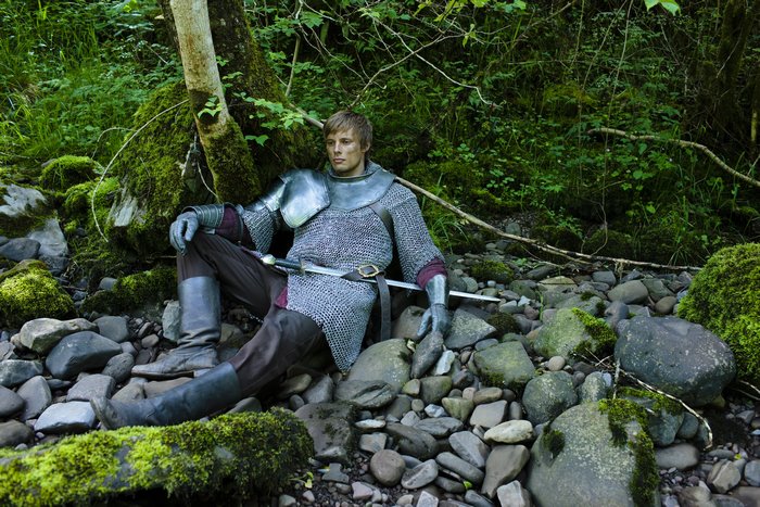 Arthur (Merlin) sitting in a forest stream