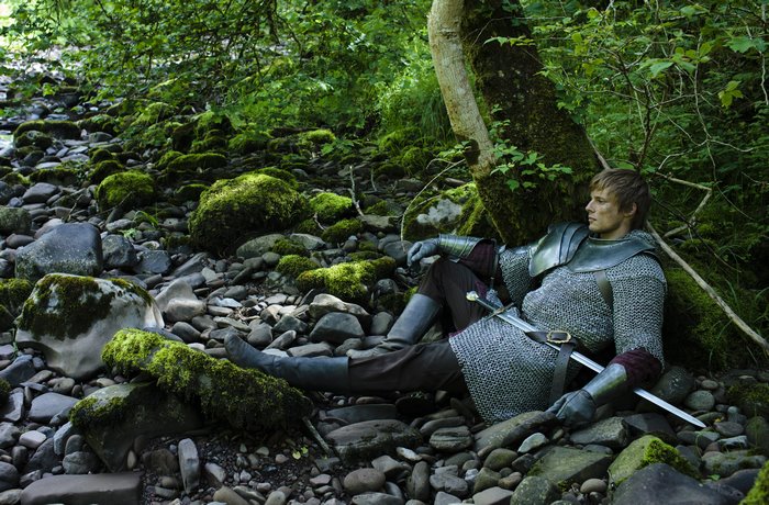 Arthur from Merlin resting by a stream