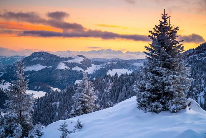 Winter sunset over snowy mountains and forest in Germany 4K