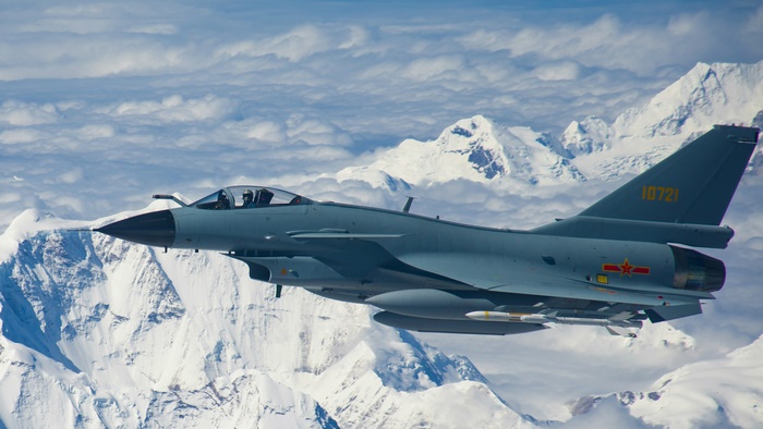 Chengdu J-10 fighter jet flying over mountains