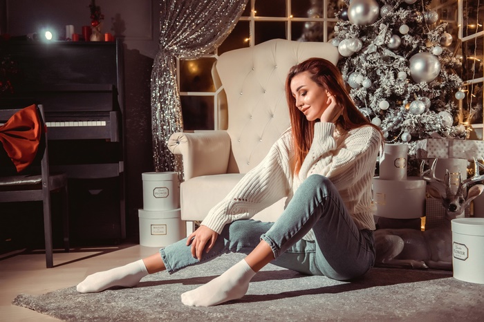 Redhead Woman Relaxing by Christmas Tree