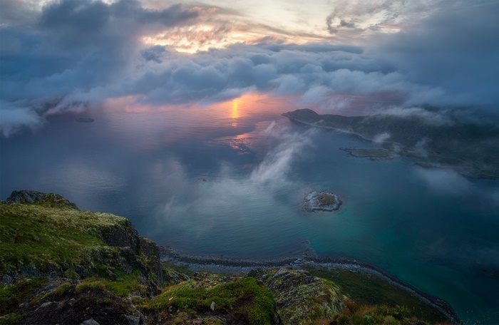 Coastal landscape with islands and clouds at sunset