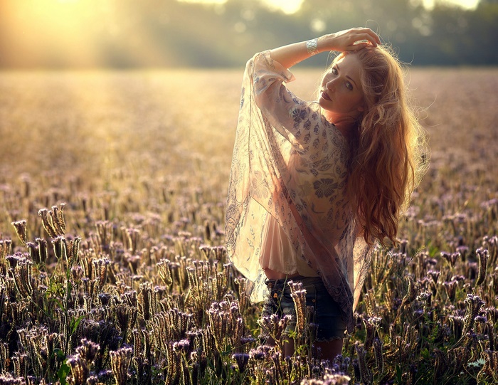 Blonde Woman in Sunlit Flower Field