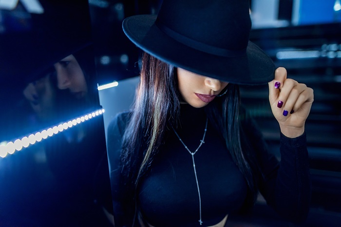 Woman in black hat and necklace
