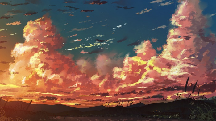 Sunset clouds over a silhouetted landscape