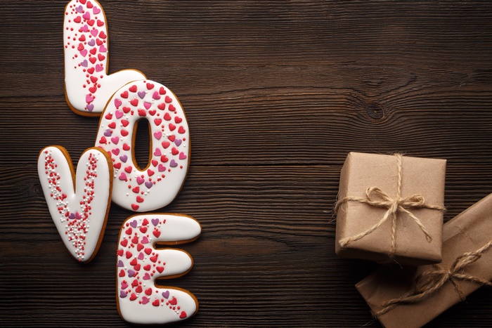 Love cookies and gifts on wooden background